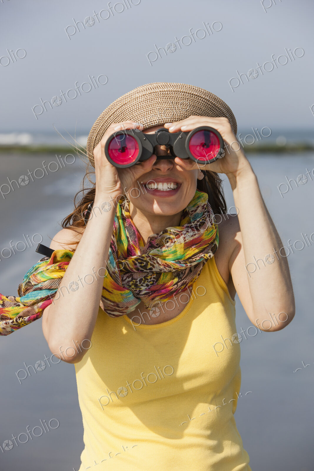 A woman in a sunhat and scarf on the beach on the New Jersey Shore, at Ocean City.