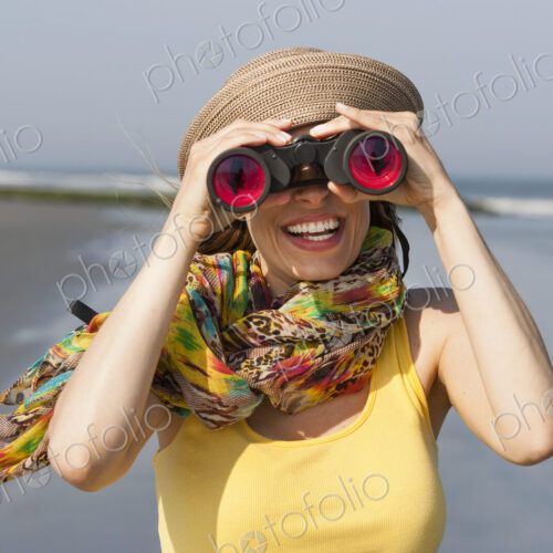 A woman in a sunhat and scarf on the beach on the New Jersey Shore, at Ocean City.
