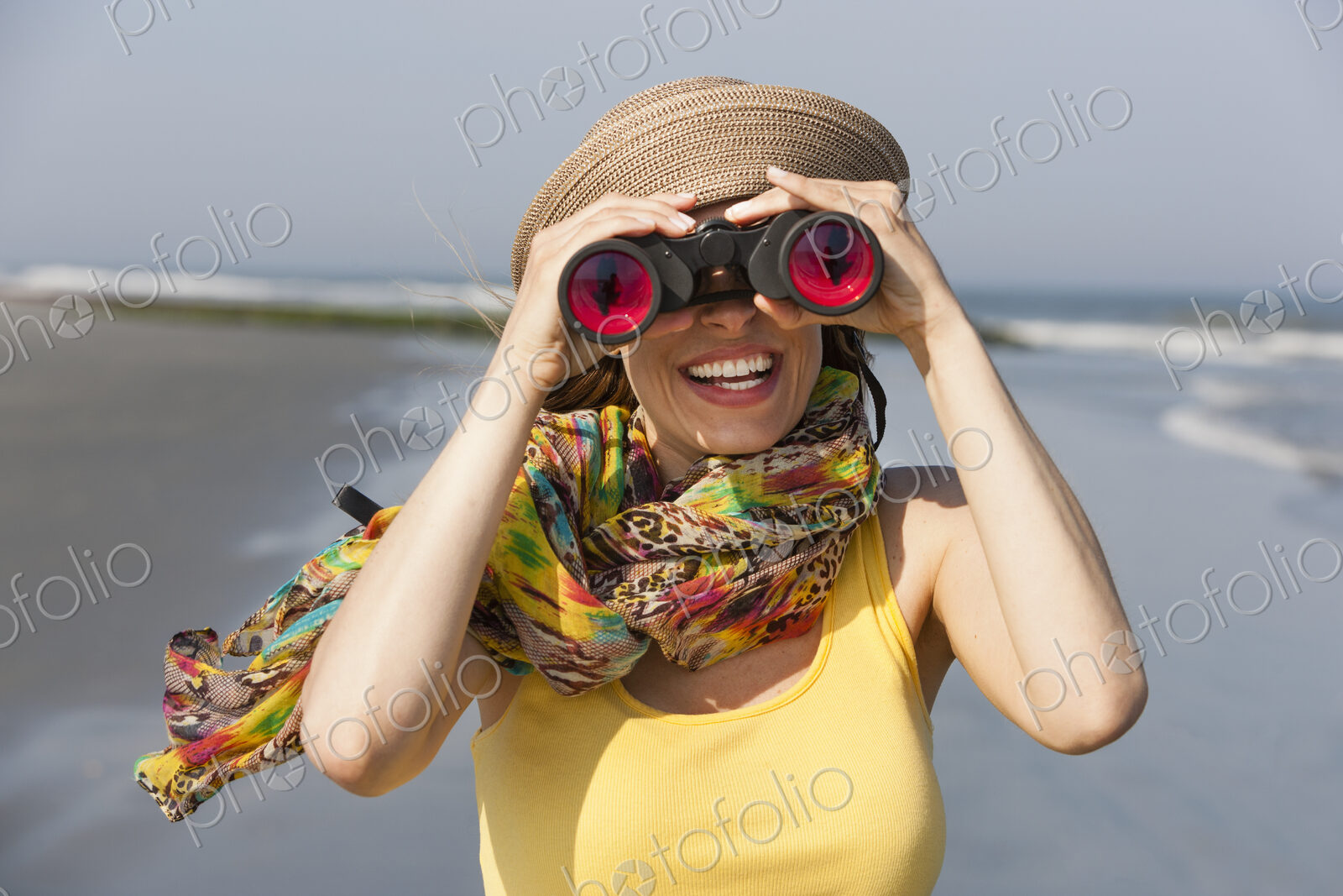 A woman in a sunhat and scarf on the beach on the New Jersey Shore, at Ocean City.