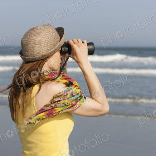 A woman in a sunhat and scarf on the beach on the New Jersey Shore, at Ocean City.