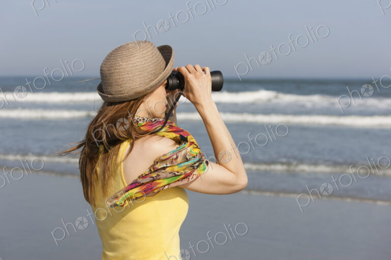A woman in a sunhat and scarf on the beach on the New Jersey Shore, at Ocean City.