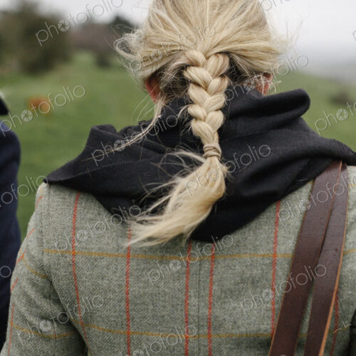 A woman in a warm tweed coat. A woman in a warm tweed coat.
