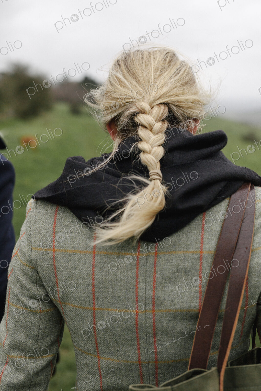 A woman in a warm tweed coat.