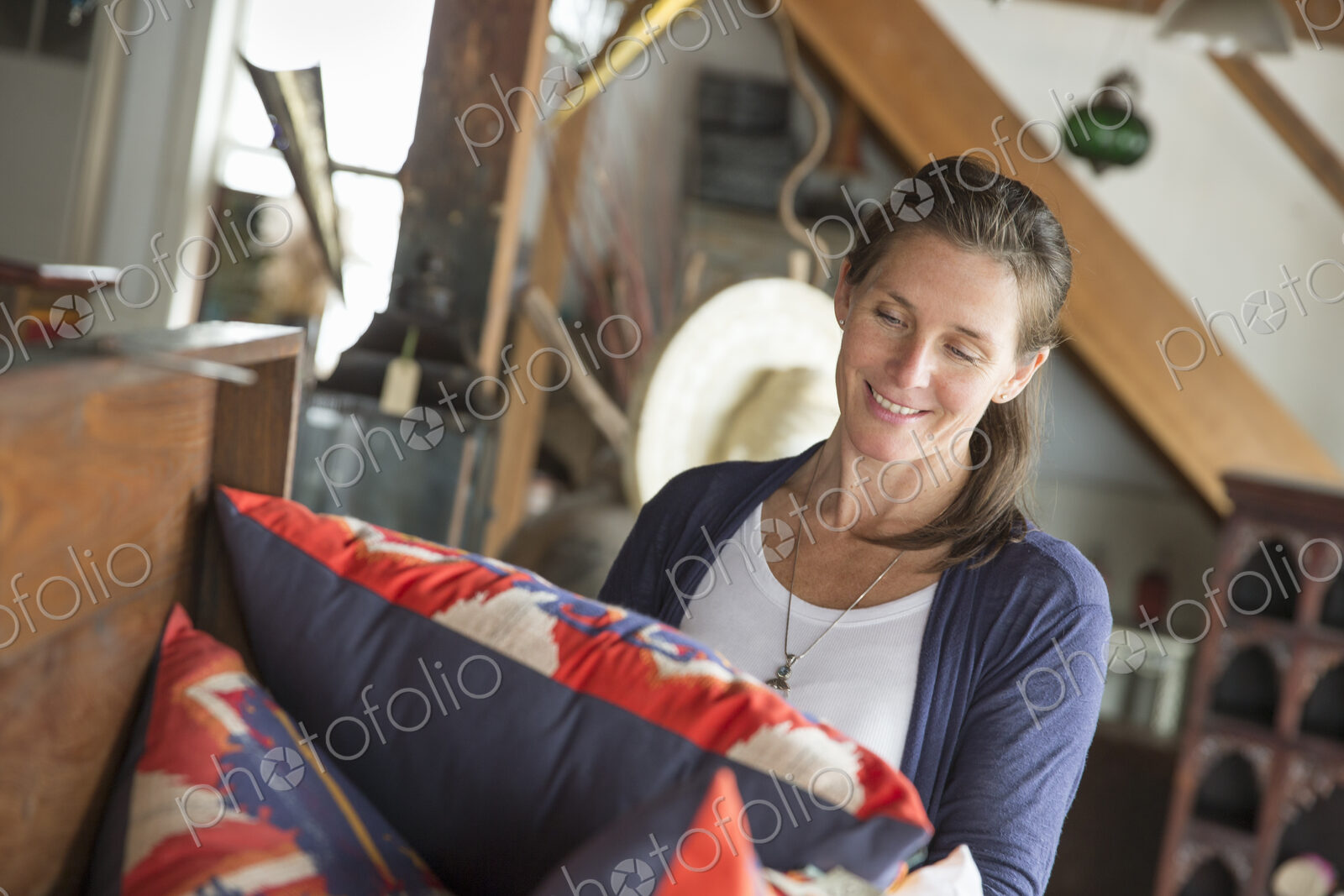 A woman in an antique store in a small town, with objects and furniture from the past.