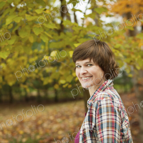 A woman in woodland on an autumn day. A woman in woodland on an autumn day.