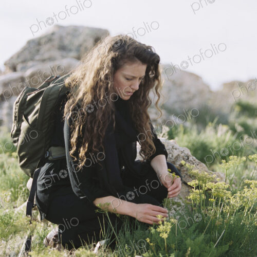 A woman picking wild flowers. A woman picking wild flowers.