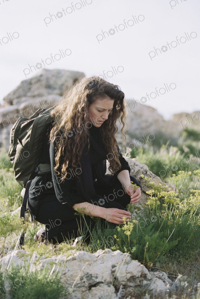 A woman picking wild flowers.