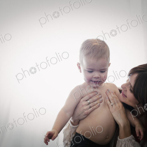 A woman playing with her young son.