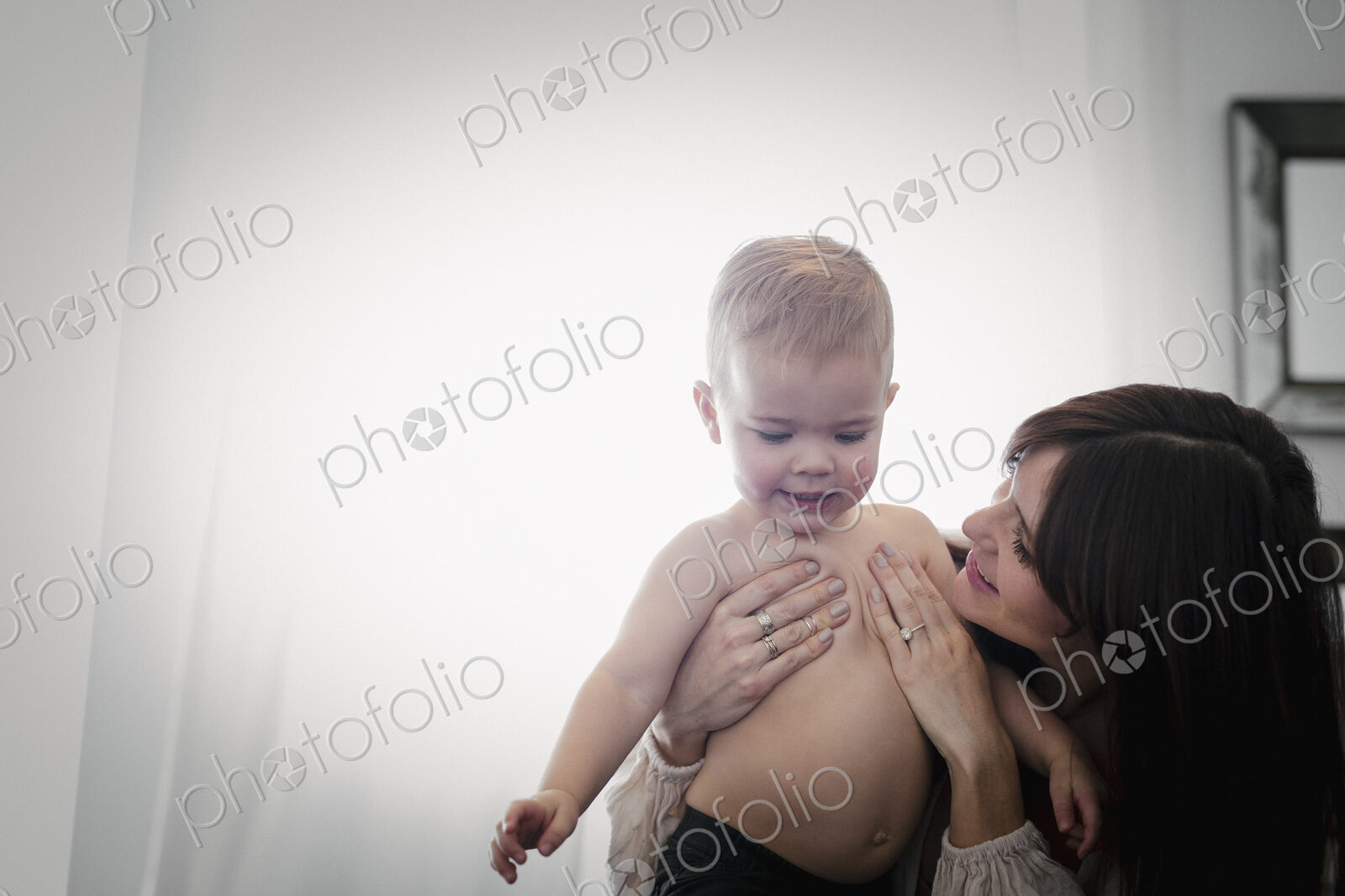 A woman playing with her young son.