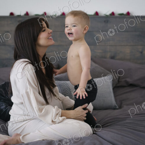 A woman playing with her young son.