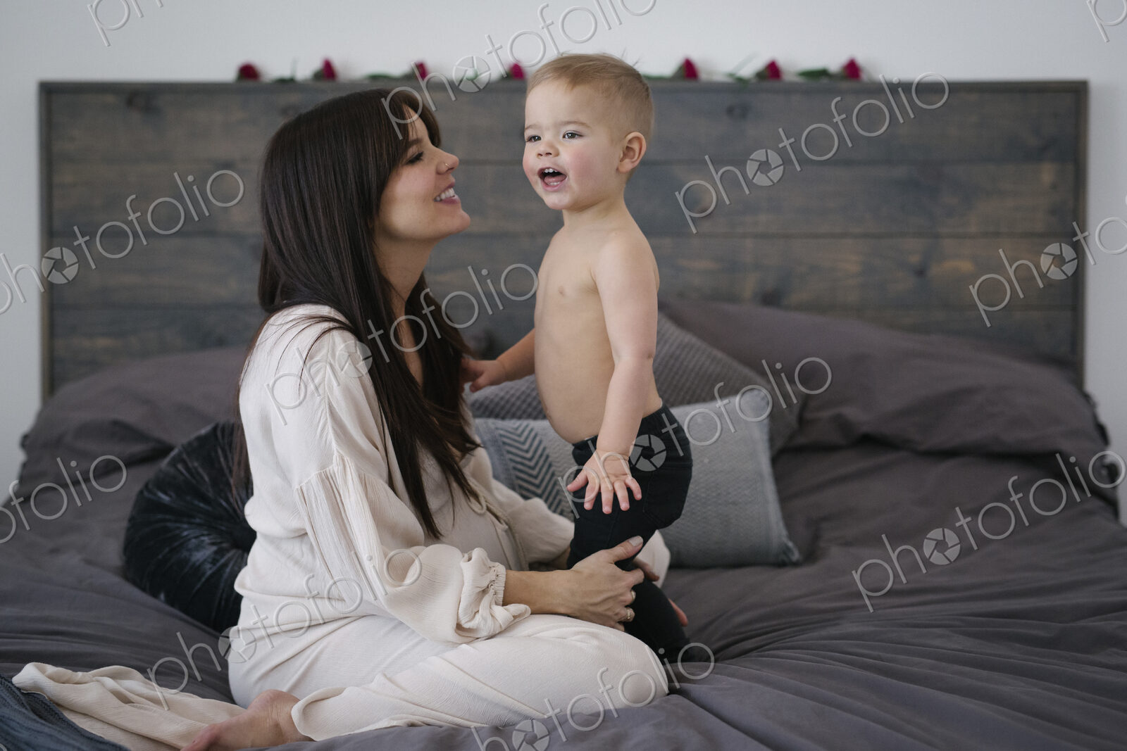 A woman playing with her young son.