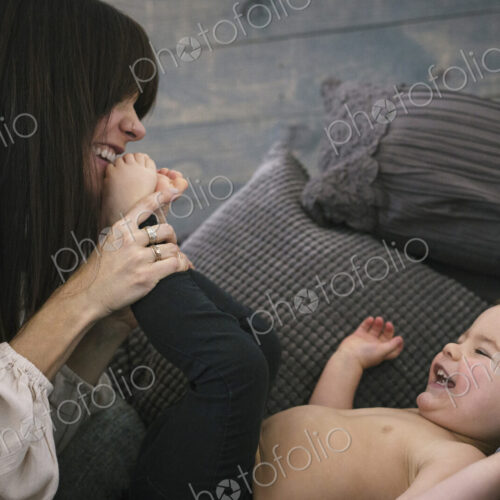 A woman playing with her young son.