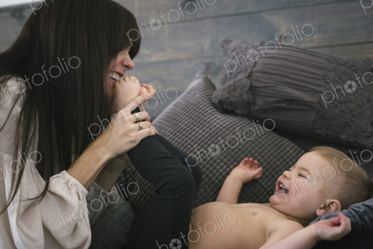 A woman playing with her young son.