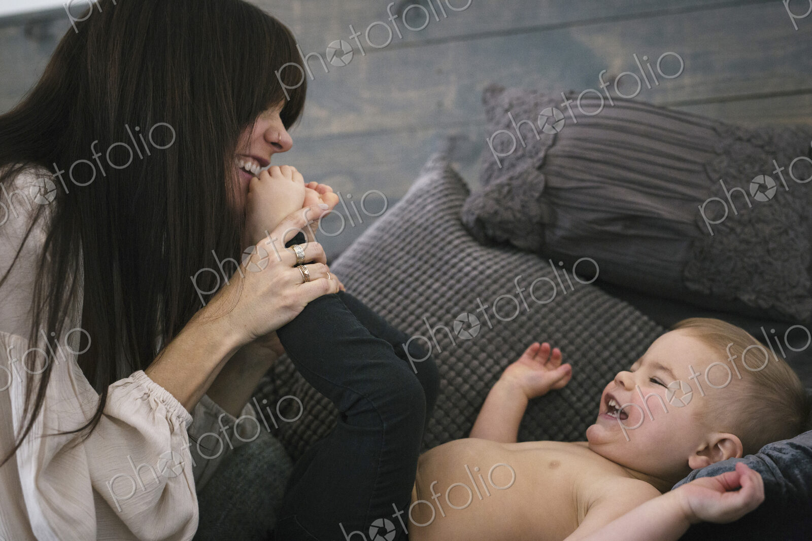 A woman playing with her young son.
