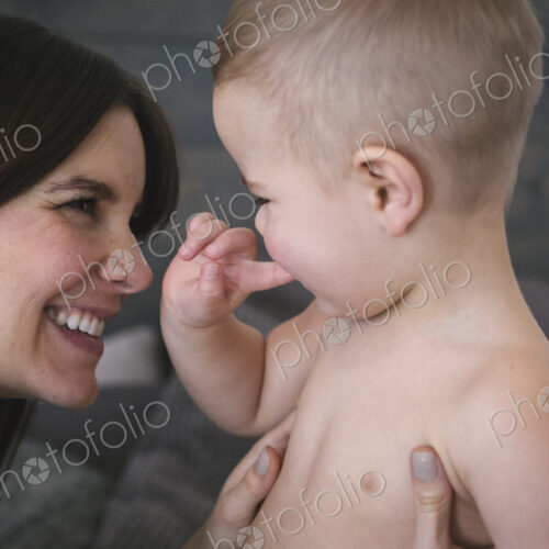 A woman playing with her young son.