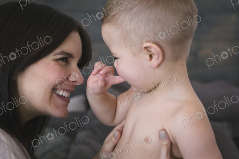 A woman playing with her young son.