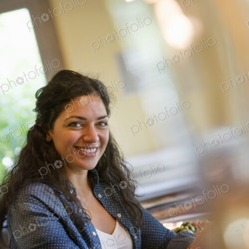 A woman seated in a cafe A woman seated in a cafe
