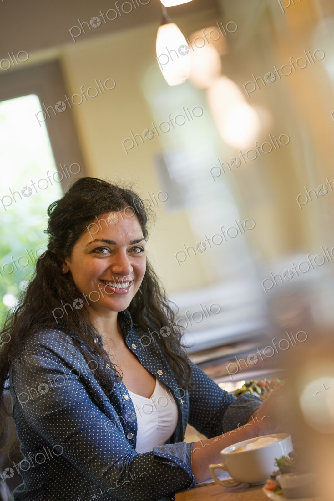 A woman seated in a cafe