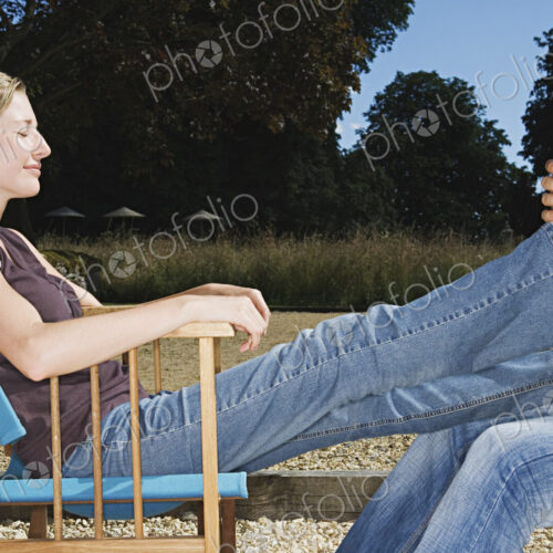 A woman seated receiving a foot massage. A woman seated receiving a foot massage.