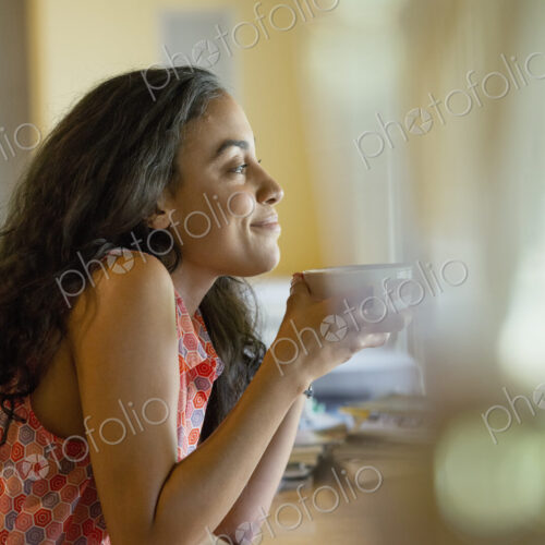 A woman sitting alone in a cafe, having coffee. A woman sitting alone in a cafe, having coffee.