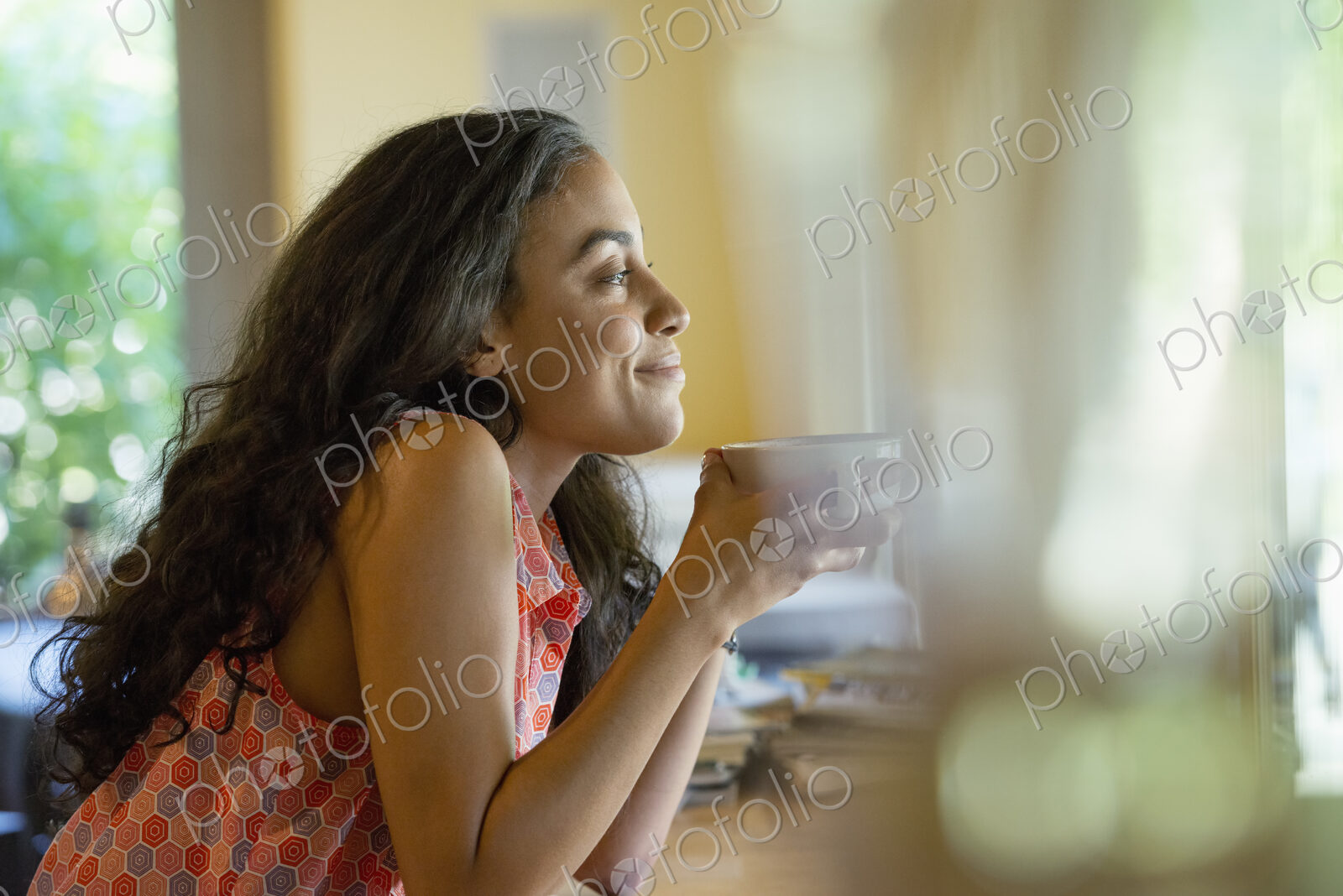 A woman sitting alone in a cafe, having coffee.