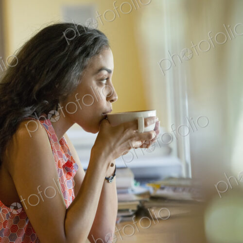 A woman sitting alone in a cafe, having coffee. A woman sitting alone in a cafe, having coffee.