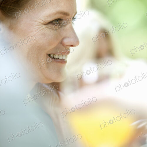 A woman sitting at a table outdoors. A woman sitting at a table outdoors.