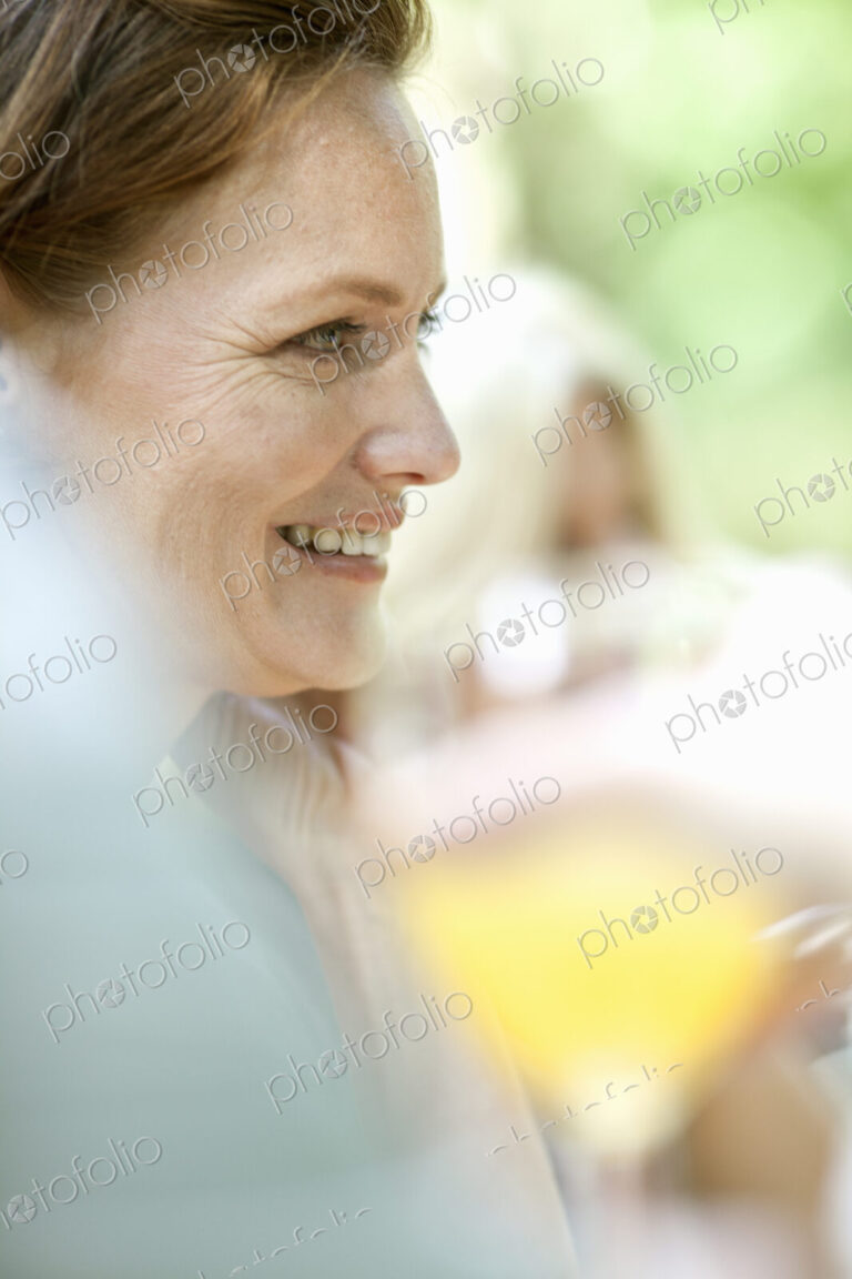 A woman sitting at a table outdoors.