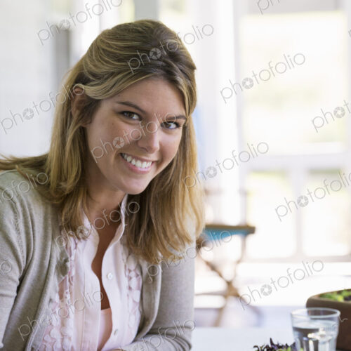 A woman sitting at a table reading a book. A woman sitting at a table reading a book.