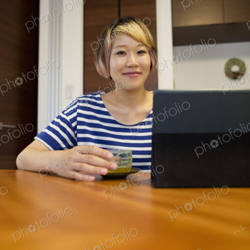 A woman sitting at a table with a laptop computer.