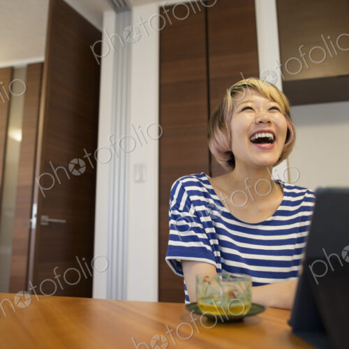 A woman sitting at a table with a laptop computer. A woman sitting at a table with a laptop computer.