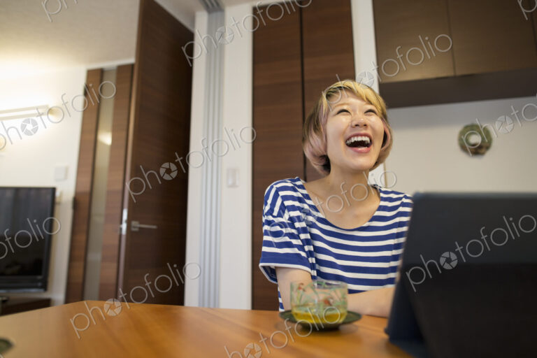 A woman sitting at a table with a laptop computer.