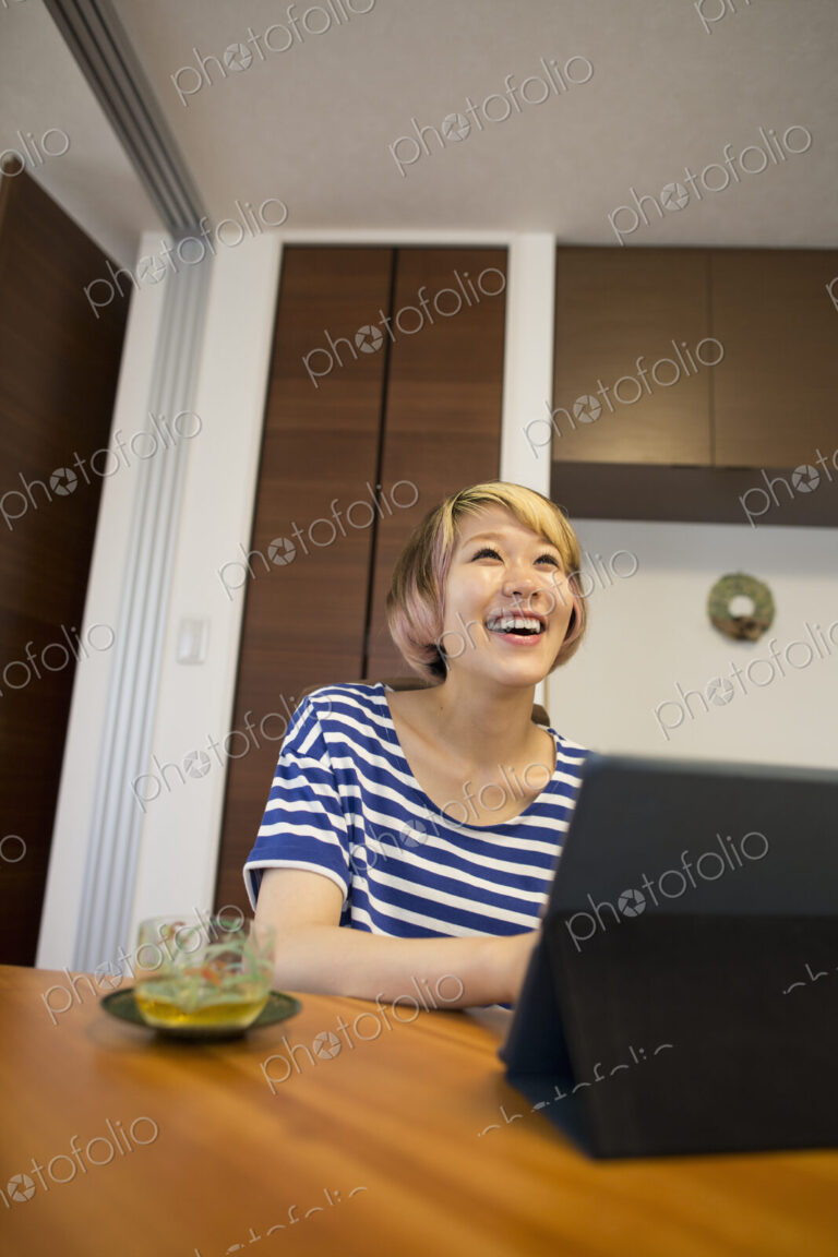 A woman sitting at a table with a laptop computer.