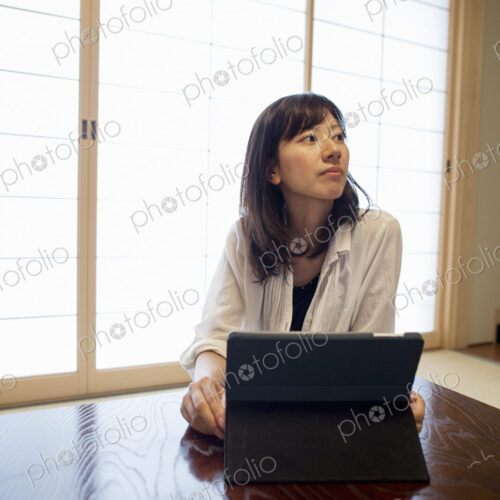 A woman sitting at a table with a laptop computer. A woman sitting at a table with a laptop computer.