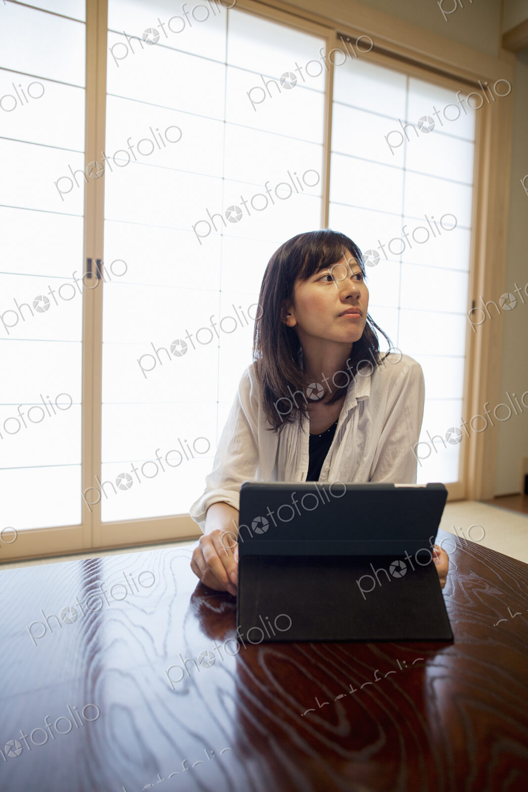 A woman sitting at a table with a laptop computer.