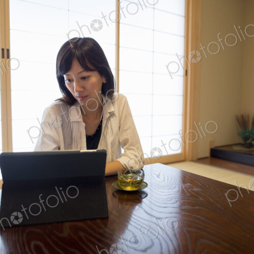 A woman sitting at a table with a laptop computer.