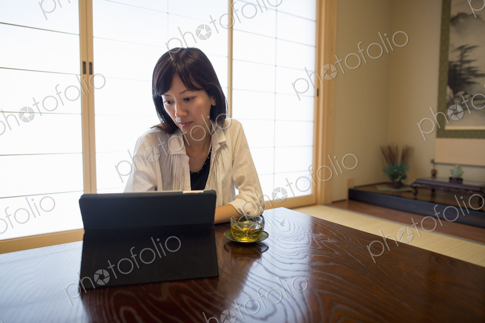 A woman sitting at a table with a laptop computer.