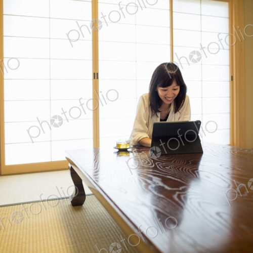 A woman sitting at a table with a laptop computer.