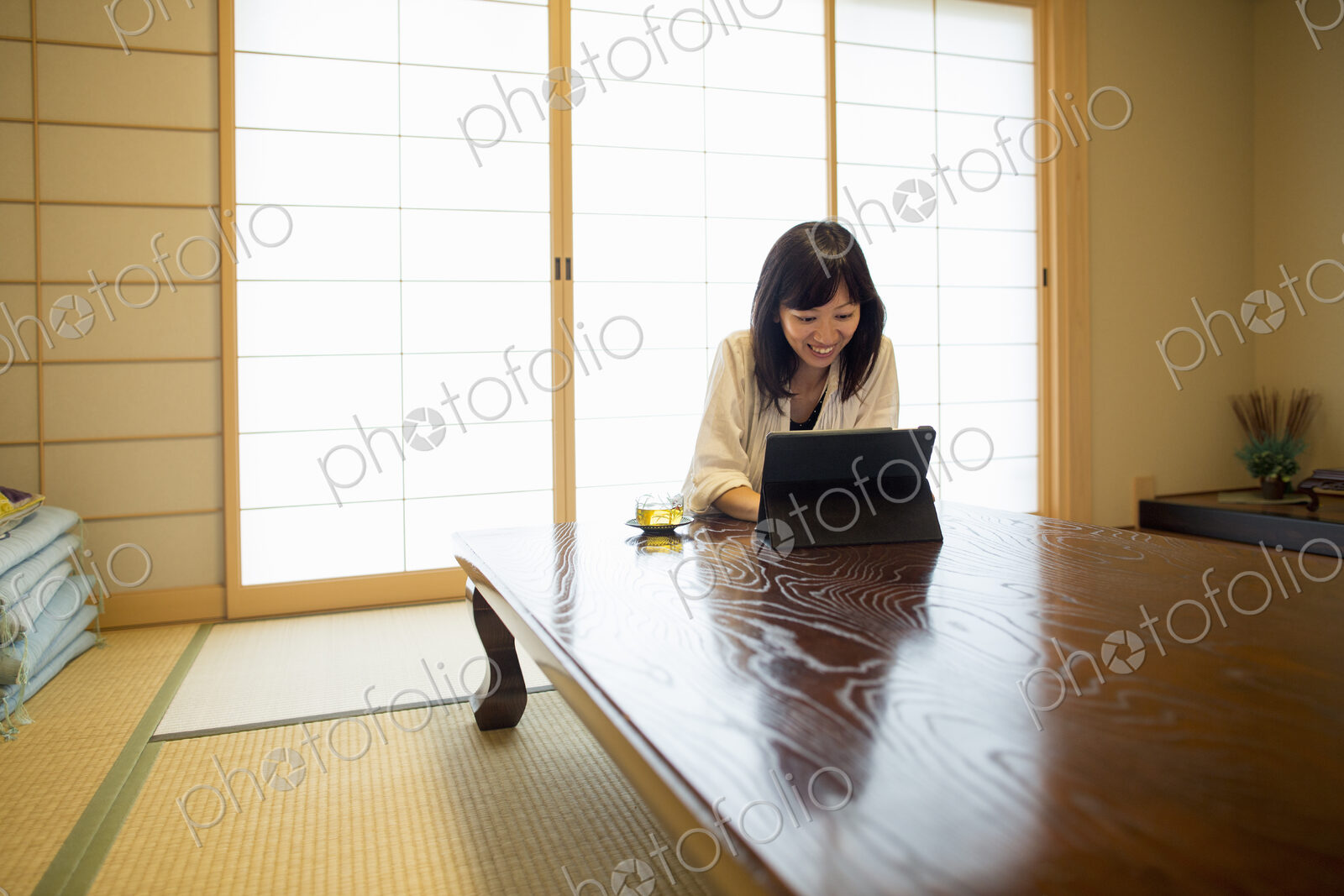 A woman sitting at a table with a laptop computer.