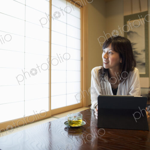 A woman sitting at a table with a laptop computer.