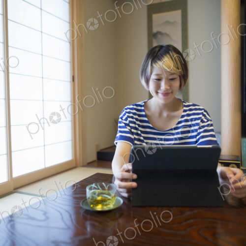 A woman sitting at a table with a laptop computer.