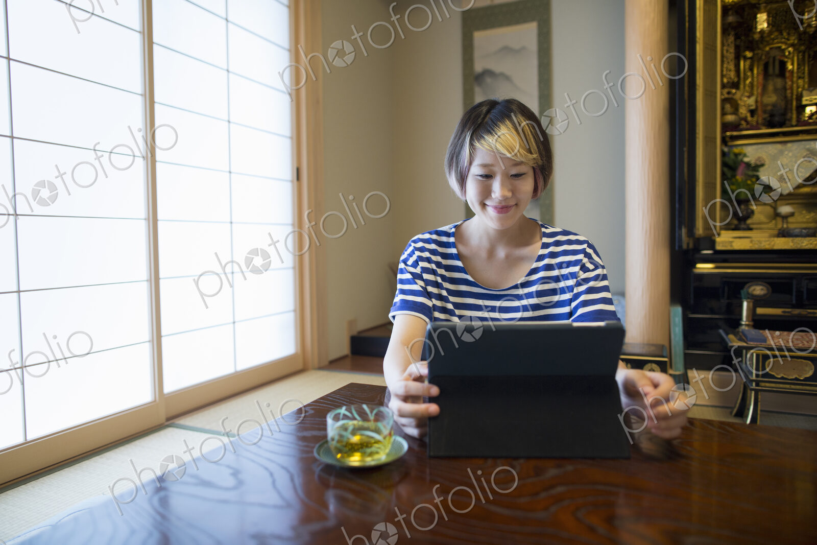 A woman sitting at a table with a laptop computer.