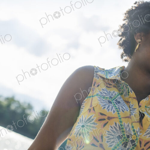 A woman smiling and laughing on a lake shore. A woman smiling and laughing on a lake shore.