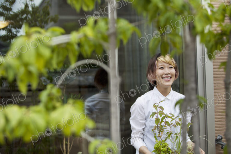 A woman standing in her garden.