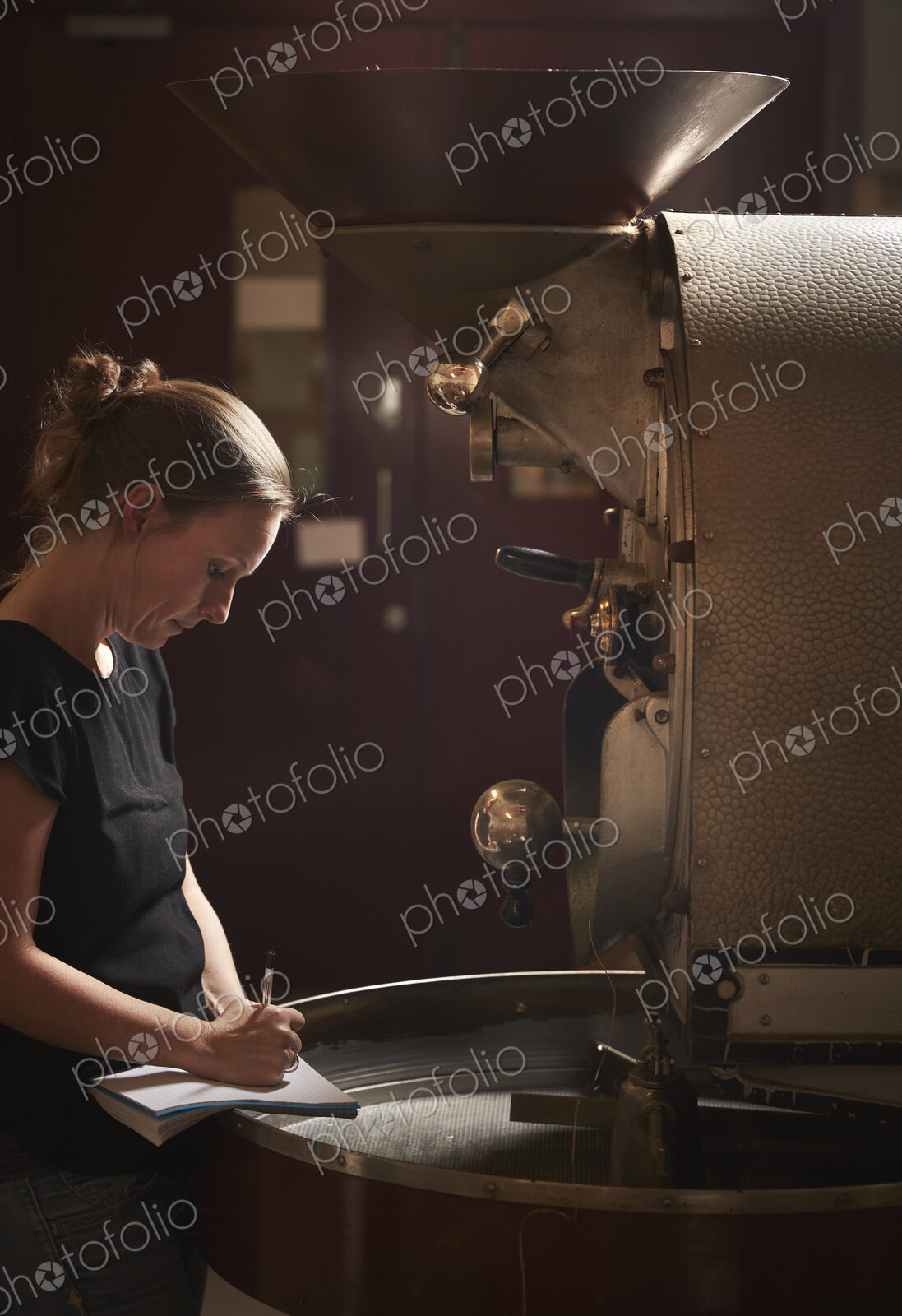 A woman testing a handful of roasted coffee beans.
