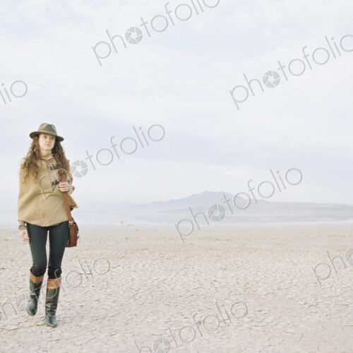 A woman walking in a desert landscape