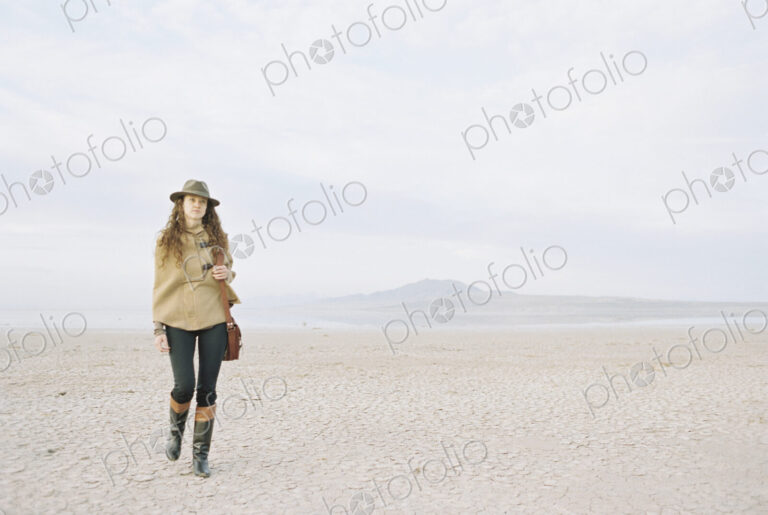 A woman walking in a desert landscape