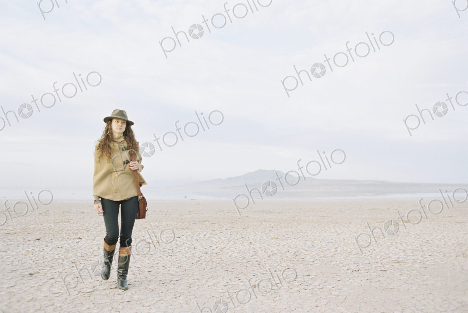 A woman walking in a desert landscape