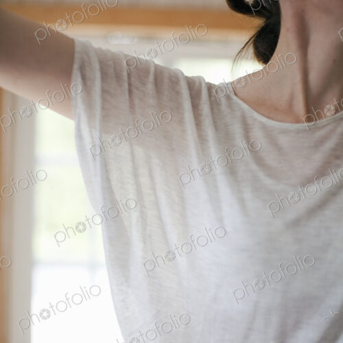 A woman wearing a light tee shirt, with her hair neatly tied back in a clip.… A woman wearing a light tee shirt, with her hair neatly tied back in a clip.…