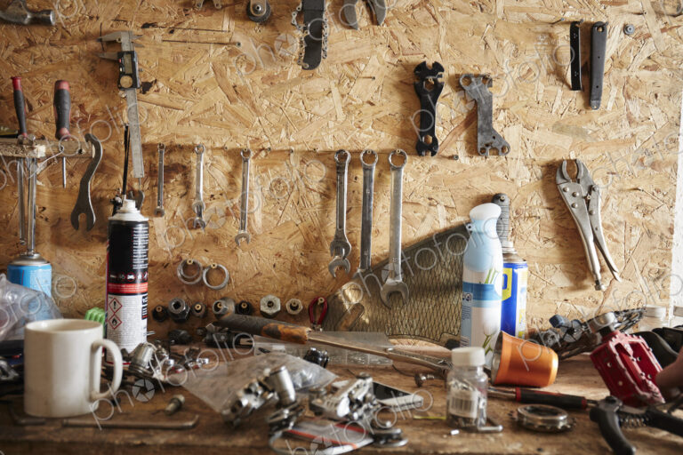 A workbench and tool board in a cycle repair shop.